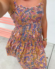 Close-up of Meadow Blooms Mauve Floral Midi Dress showing detailed smocked bodice, tie straps, and vibrant floral pattern.