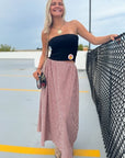 Crimson gingham maxi skirt with elastic waist, paired with a black top and boots, ideal for fall gameday or Thanksgiving outfits.