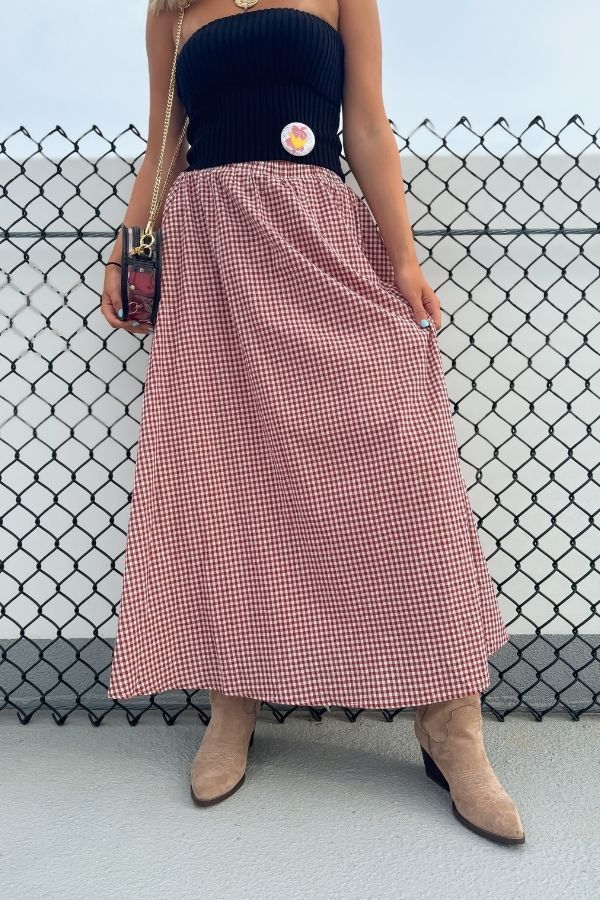 Put Me In Crimson Gingham Maxi Skirt styled with a black strapless top and suede boots, perfect for a classic gameday look.