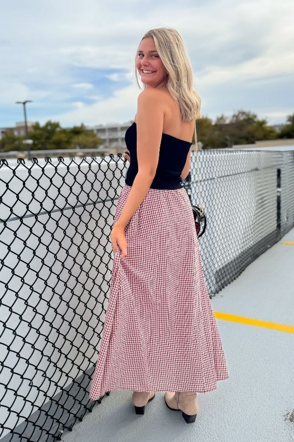 Back view of the Put Me In Crimson Gingham Maxi Skirt showing its flowy silhouette and timeless gingham pattern for gameday style.