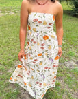 Heirloom Pumpkin Harvest Strapless Midi Dress with fall-themed print, worn outdoors, ideal for Thanksgiving and autumn events.