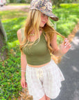 Eleanor Brown Patterned Flowy Shorts paired with a camo cap and green tank, ideal for casual wear with breathable material and flattering silhouette.