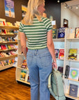 Rear view of Easy A Green Striped Baby Tee styled with straight-leg jeans, perfect for a laid-back, back-to-school outfit.