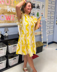 Better In Yellow Ruffle Mini Dress styled with platform sandals, featuring high neckline and vibrant geometric print for a fresh summer vibe.