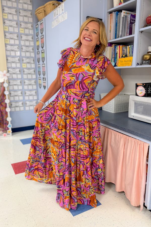 Purple Leaf Maxi Dress - Multicolor Print with flowy fit and ruffle sleeves, styled for back to school in a classroom setting.