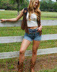Saddle Up in Style with Rodeo Star Black & Brown Suede Fringe Vest featuring star detail and western fringe, styled with denim shorts and cowboy boots.