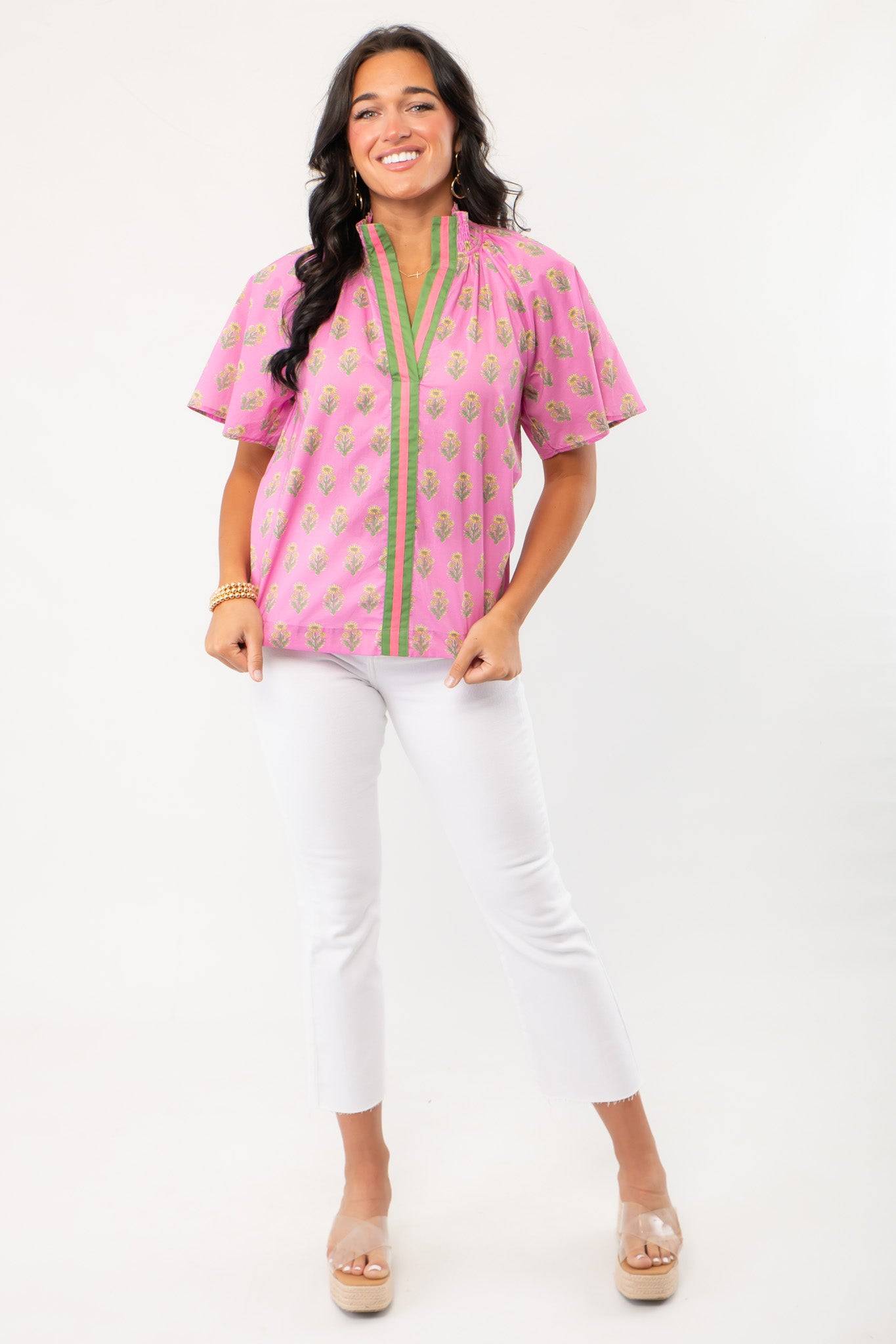THML Pink Floral Smocked Neck Top with green trim and block print design, styled with white cropped pants. A stylish spring essential for casual wear.