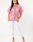 THML Pink Floral Smocked Neck Top with green trim and block print design, styled with white cropped pants. A stylish spring essential for casual wear.