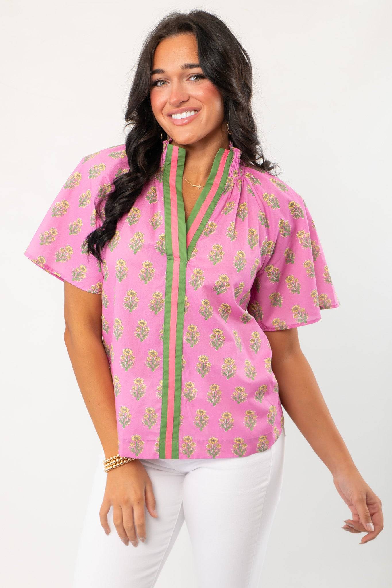 THML Pink Floral Smocked Neck Top with green trim and short sleeves, perfect for spring fashion. Features block print floral pattern and V-neckline.