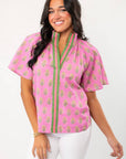 THML Pink Floral Smocked Neck Top with green trim and short sleeves, perfect for spring fashion. Features block print floral pattern and V-neckline.