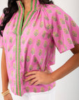 THML Pink Floral Smocked Neck Top with green-trimmed V-neckline and short sleeves, perfect for spring fashion in women's clothing tops.
