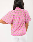 Back view of THML Pink Floral Smocked Neck Top featuring a block print floral pattern and short sleeves, ideal for spring fashion.