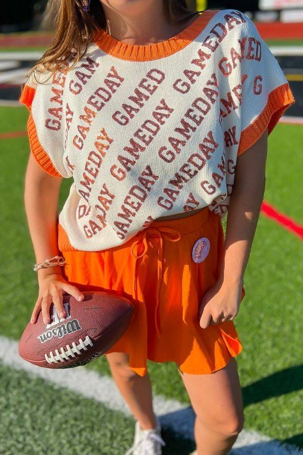Close-up of GAMEDAY Orange & White Sequin Sweater Vest featuring bold text design. Ideal for summer tailgates and school spirit events.