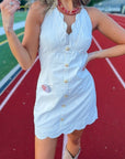 Close-up of Ellie Beige Halter Neck Scalloped Mini Dress featuring scalloped neckline, button front, and side pockets, ideal for casual outings.
