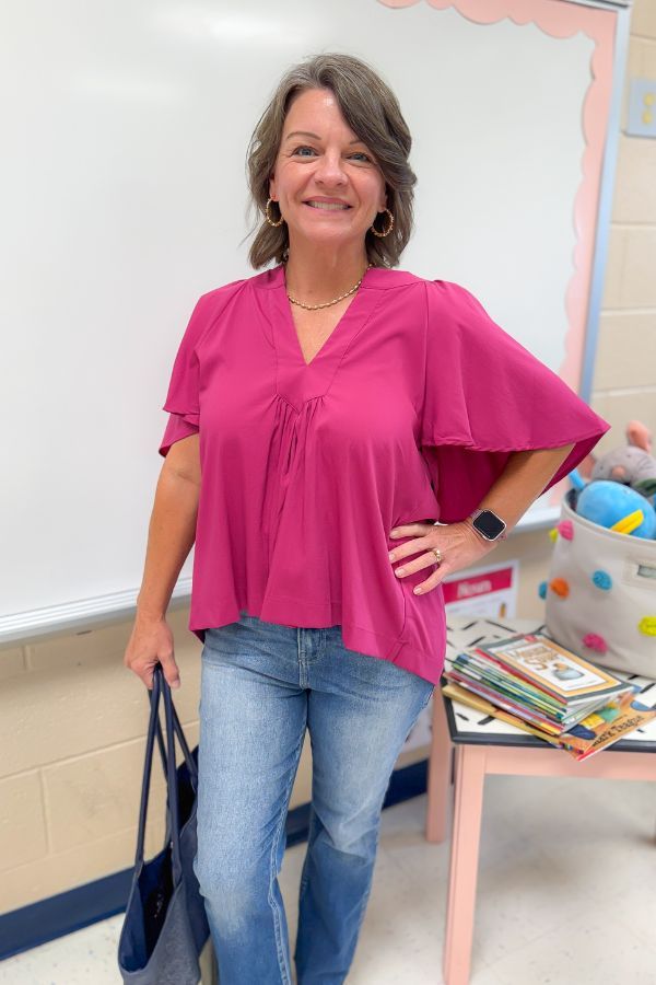 Very Berry Tunic Top - Pinch Pleated in vibrant berry pink with flowy short sleeves and V-neck, styled with jeans for a casual-chic look.