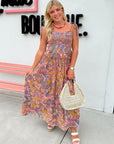 Woman in a floral dress standing in front of a store with a pink bench.