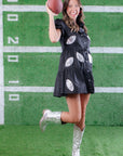 Game day-ready Black Sequin Football Dress with puff sleeves and tiered design, styled with silver cowboy boots for a sporty-chic look.