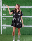 Trendy Black Sequin Football Dress with playful silver football patches, ideal for standing out at tailgates and sports events.