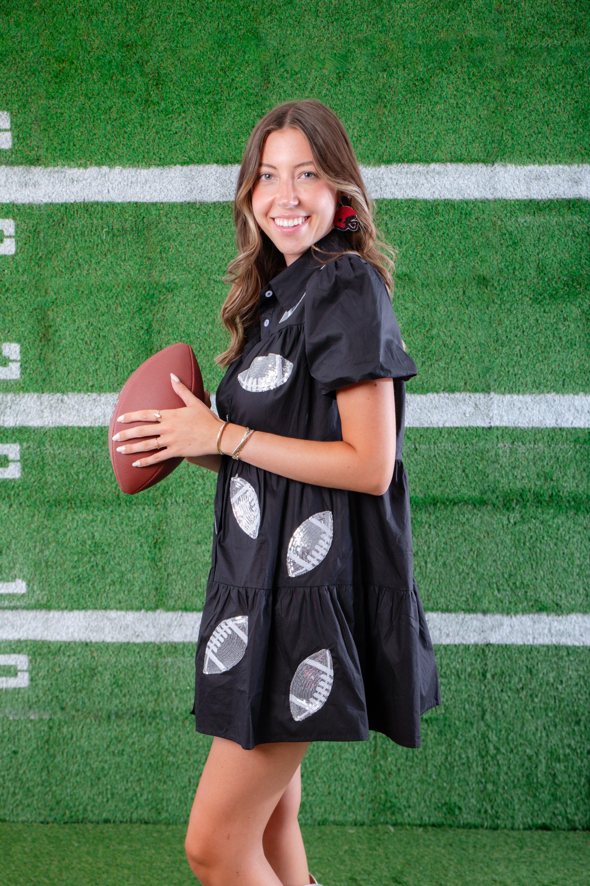 Chic Black Sequin Football Dress with a relaxed fit and button-up front, styled for a fashionable game day outfit.