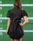 Back view of the Black Sequin Football Dress showcasing its tiered design and puff sleeves, perfect for a sporty yet stylish outfit.