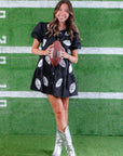 Fun and fashionable Black Sequin Football Dress with silver football patches, styled with silver boots for the ultimate game day outfit.