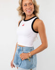 Side view of the Cherry On Top Halter Neck Tank styled with denim shorts and gold accessories. A flattering and fashionable choice for casual summer looks.