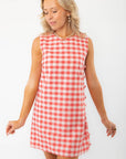 Front view of Poppy Red Gingham Mini Dress with side buttons, highlighting its vibrant checkered pattern and relaxed summer style.