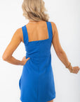 Back view of a blue mini dress with a square neckline and concealed zipper. The sleek design offers a polished and elegant finish for any occasion.
