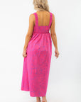Back view of the Show Me Your Mumu Pink Shells Fling Midi Dress showcasing its smocked back detail and flowy silhouette for a breezy summer look.