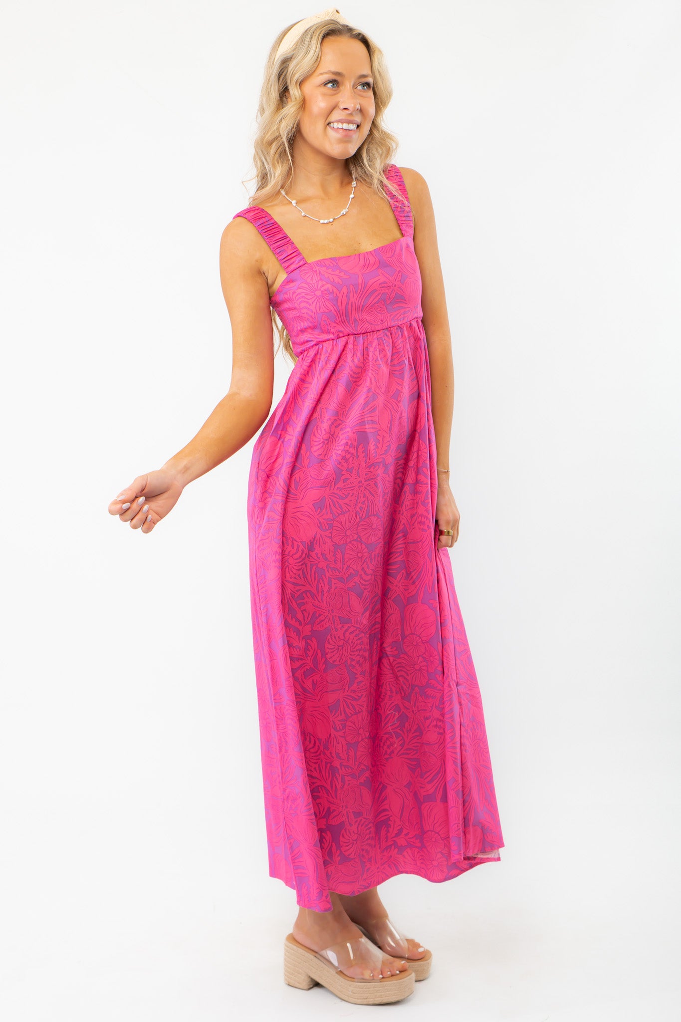 Side view of the Show Me Your Mumu Pink Shells Fling Midi Dress highlighting its flattering empire waist and lightweight fabric for effortless style.