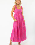 Show Me Your Mumu Pink Shells Fling Midi Dress featuring a vibrant pink tropical print, smocked back, and elastic straps for a comfortable fit.