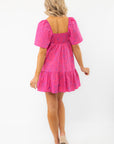 Back view of the Show Me Your Mumu Pink Shells Erin Mini Dress showcasing smocked detailing and a flowy silhouette.