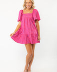 Model twirling in the Show Me Your Mumu Pink Shells Erin Mini Dress, a playful and stylish choice for summer vacations.