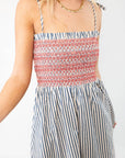 Close-up of THML Smocked Blue Striped Tie Strap Midi Dress showing red smocked bodice and blue vertical stripes, perfect for casual summer wear.
