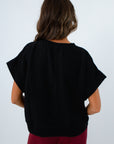 Comfortable brushed knit top with short sleeves for transitional seasons, elevated basic black knit top for fall