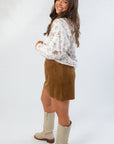 Side view of Snuggle Pup Dog Print Sweatshirt showing relaxed fit and playful dog pattern, styled with a brown skirt and cream boots.