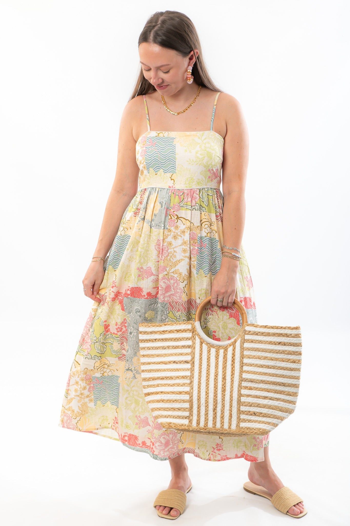 MinkPink Aurora Strappy Patchwork Midi Dress - Dreamy Elegance with floral pastel panels, adjustable straps, and pockets, styled with a straw tote.