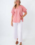 gingham check blouse with white jeans and gold jewelry