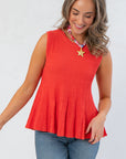 Close-up of Papaya Flared Rib Knit Top showing ribbed texture and flared hem, ideal for casual or dressy occasions in bright seasonal colors.