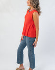 Side view of Papaya Flared Rib Knit Top highlighting the sleeveless cut and flared peplum design, perfect for layering or standalone wear.