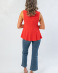 Back view of Papaya Flared Rib Knit Top with ribbed knit texture and flared hem, offering a flattering fit for versatile styling.