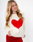 Close-up of Cupid Crush Heart Cropped Sweater in soft white knit with large red heart, ideal for cozy Valentine's Day outfits.