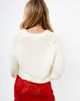 Back view of Cupid Crush Heart Cropped Sweater showing chunky white knit texture and relaxed cropped fit for casual layering.