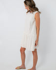 Back view of white cotton scallop hem mini dress with keyhole closure