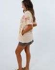 Lightweight beige t shirt with floral and butterfly print, oversized t shirt with floral design and side pockets