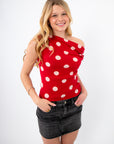 Retro Romance Red Polka Dot Asymmetrical Top worn off-shoulder, paired with a black skirt for a flirty Galentine-to-Valentine look.