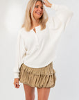 Free People Ivory Quinn Knit Top with textured waffle knit and button neckline, styled for women’s casual wear in neutral tones.