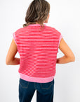 Back view of Piper Pink Stripe Short Sleeve Cardigan showing horizontal pink and red stripes and ribbed waistband for a cozy spring look.