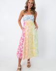 Model wearing rainbow floral sleeveless midi dress with adjustable straps
