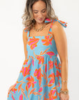 Close-up of THML Tie Strap Flower Print Maxi Dress showing tie straps and square neckline, ideal for stylish vacation wear.